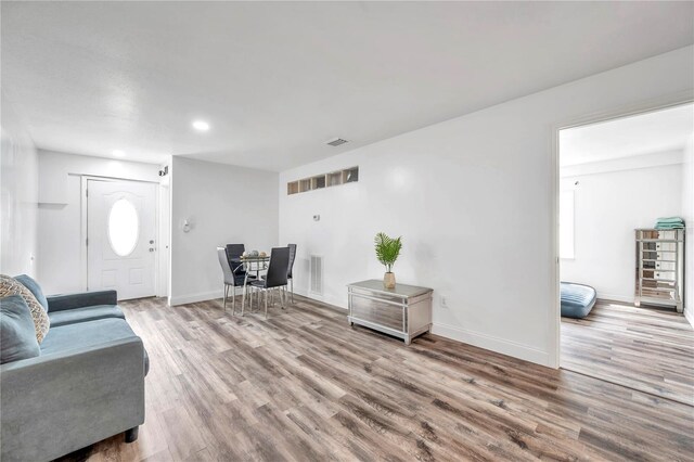 living room with a healthy amount of sunlight and hardwood / wood-style flooring