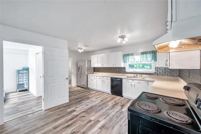 kitchen with light hardwood / wood-style floors, sink, white cabinets, black appliances, and exhaust hood