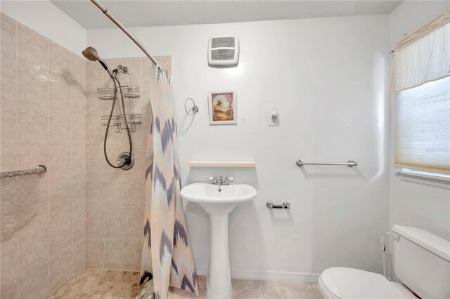 bathroom with sink, curtained shower, and toilet