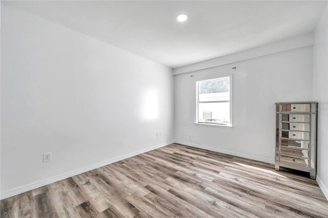 spare room featuring light hardwood / wood-style floors