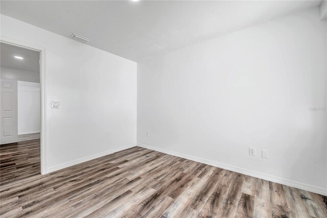 unfurnished room featuring hardwood / wood-style flooring