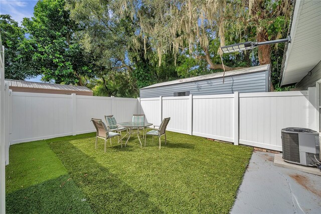 view of yard with central AC and a patio area