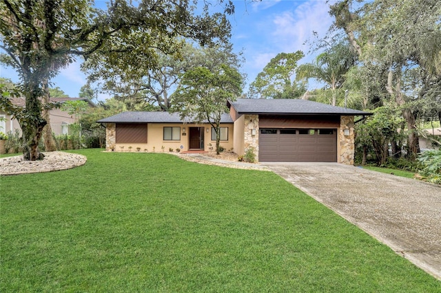 view of front of house with a front yard and a garage