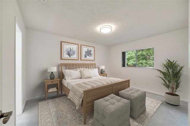 carpeted bedroom featuring a textured ceiling