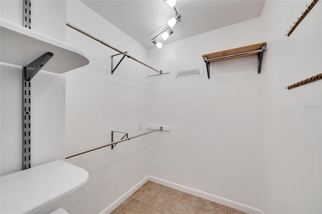 spacious closet with light tile patterned floors