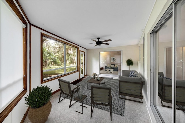 sunroom featuring ceiling fan