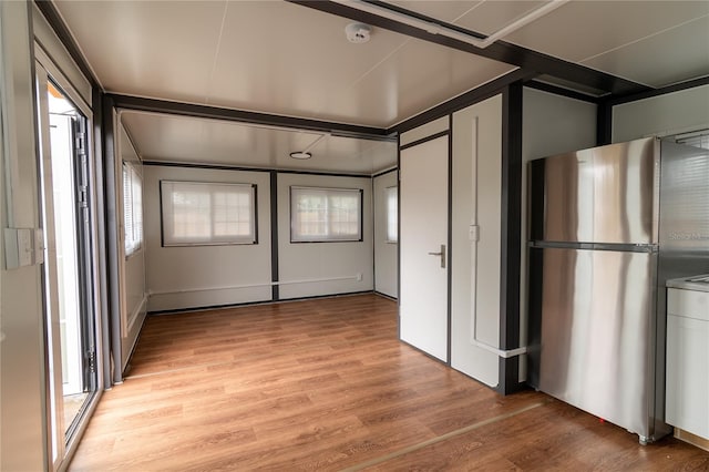 kitchen with light hardwood / wood-style floors and stainless steel refrigerator