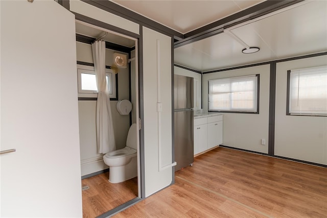 bathroom featuring hardwood / wood-style floors and toilet