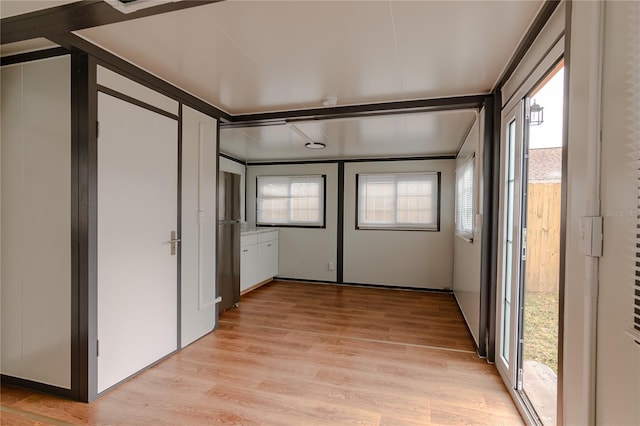 interior space with beamed ceiling and light wood-type flooring