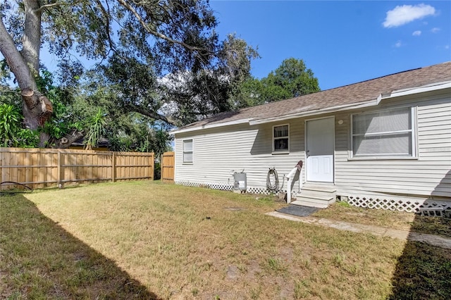 rear view of house featuring a yard