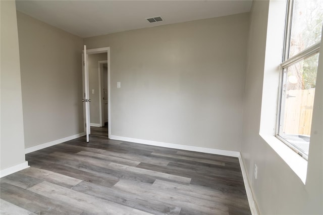 empty room featuring hardwood / wood-style flooring and plenty of natural light