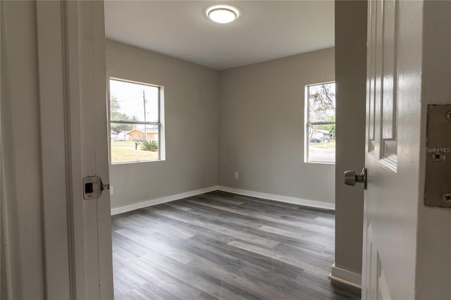 empty room featuring plenty of natural light and hardwood / wood-style flooring