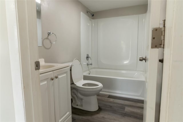 full bathroom featuring hardwood / wood-style floors, vanity, shower / bathtub combination, and toilet