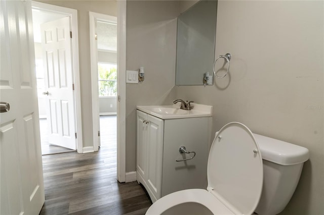 bathroom with hardwood / wood-style flooring, vanity, a textured ceiling, and toilet