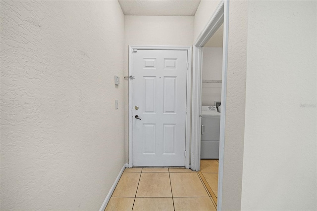 interior space featuring washer / clothes dryer and light tile patterned floors