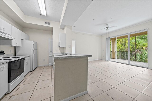 kitchen with light tile patterned floors, white appliances, white cabinetry, and ceiling fan