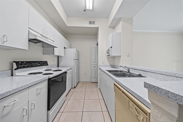 kitchen featuring white cabinets, white appliances, light stone countertops, light tile patterned floors, and sink