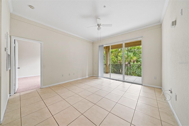 tiled empty room featuring ceiling fan and crown molding