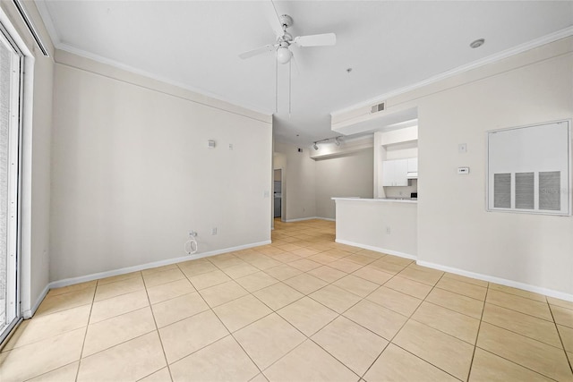 empty room with crown molding, light tile patterned flooring, and ceiling fan