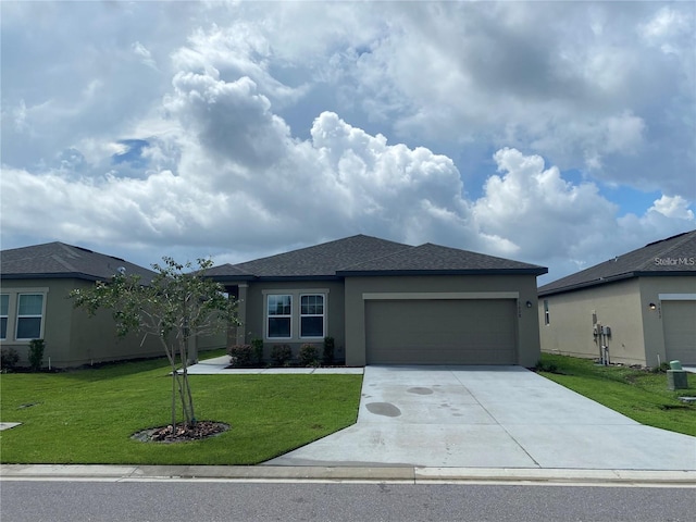 view of front of house featuring a front yard and a garage