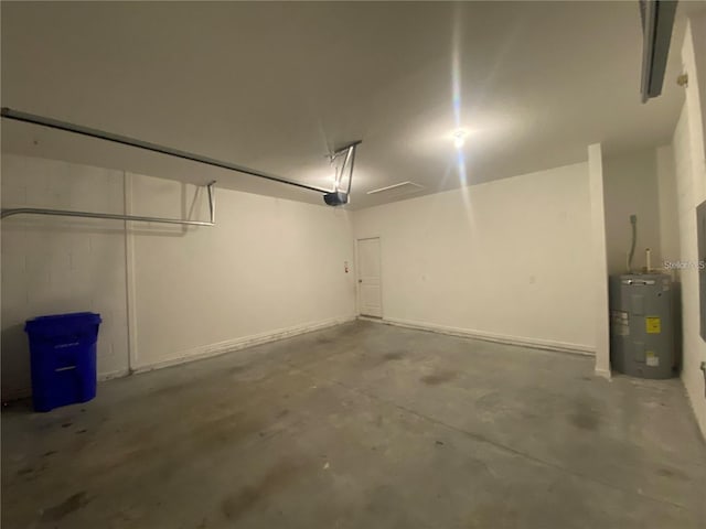 garage with a garage door opener and water heater