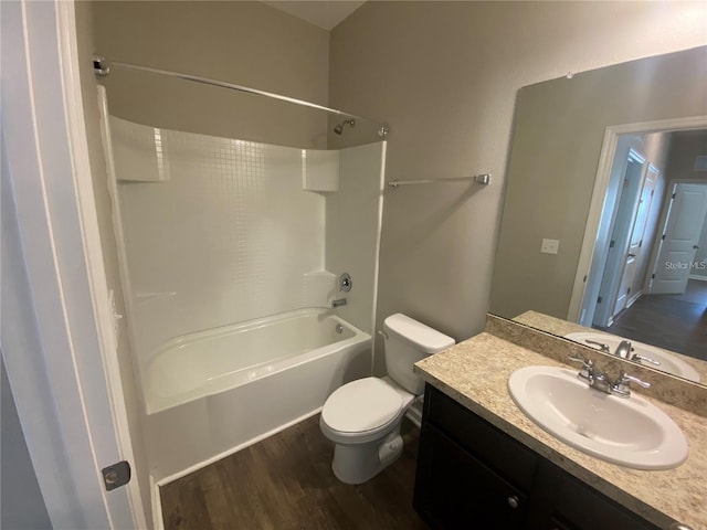 full bathroom with vanity, hardwood / wood-style floors, toilet, and shower / bathtub combination