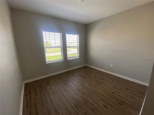 spare room featuring dark hardwood / wood-style flooring