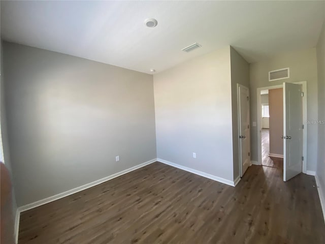 unfurnished room with dark hardwood / wood-style floors