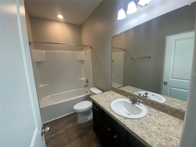 full bathroom featuring shower / washtub combination, hardwood / wood-style floors, vanity, and toilet