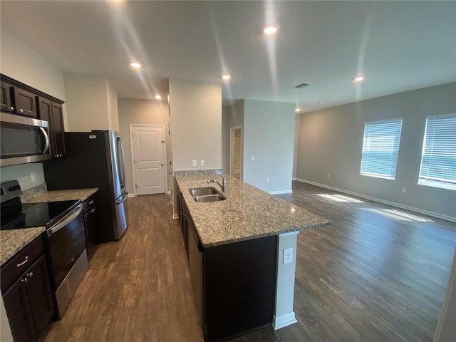 kitchen featuring dark hardwood / wood-style floors, sink, appliances with stainless steel finishes, dark brown cabinetry, and light stone countertops