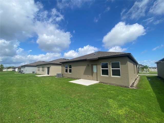 back of property featuring central AC, a patio area, and a yard