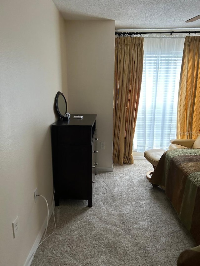 carpeted bedroom featuring a textured ceiling