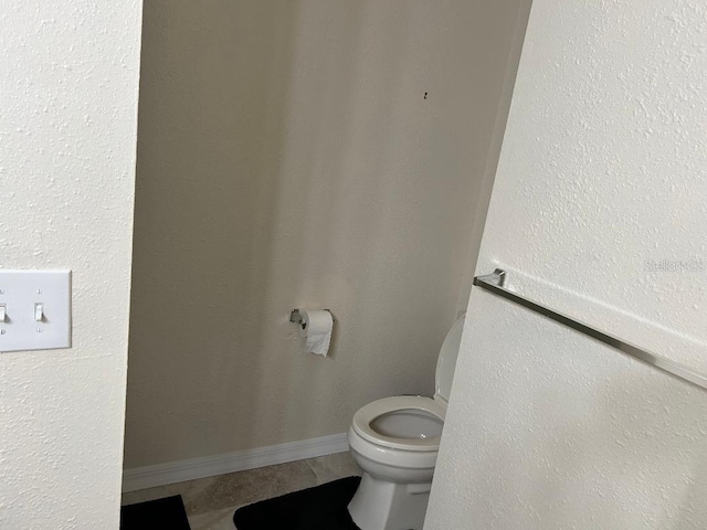 bathroom featuring toilet and tile patterned floors