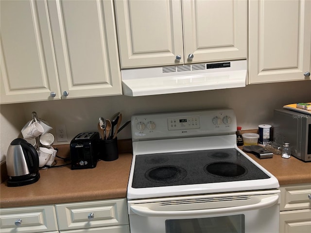 kitchen with white electric range, range hood, and white cabinets