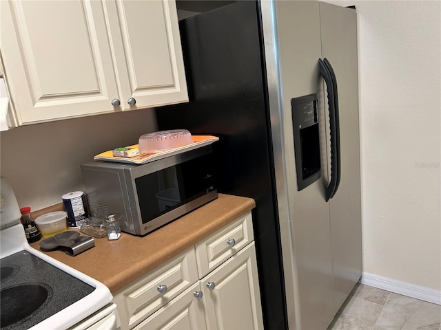 kitchen featuring white range and white cabinets