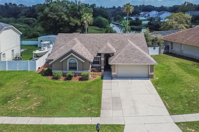 view of front facade with a garage and a front lawn