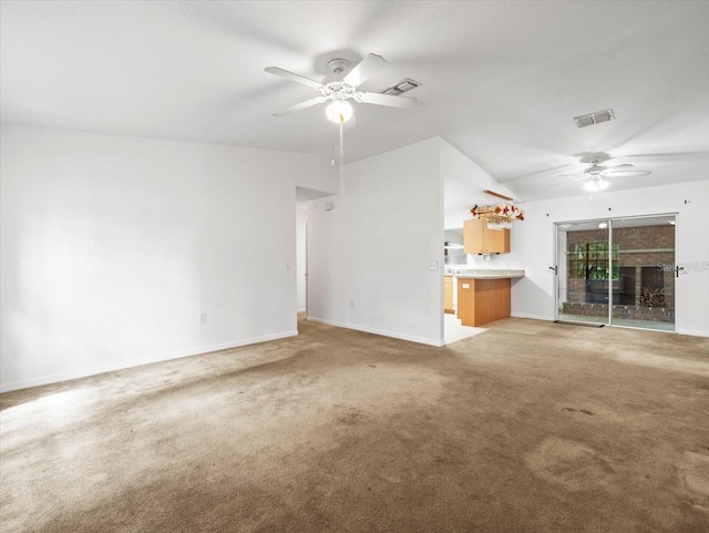 unfurnished living room featuring carpet, lofted ceiling, and ceiling fan