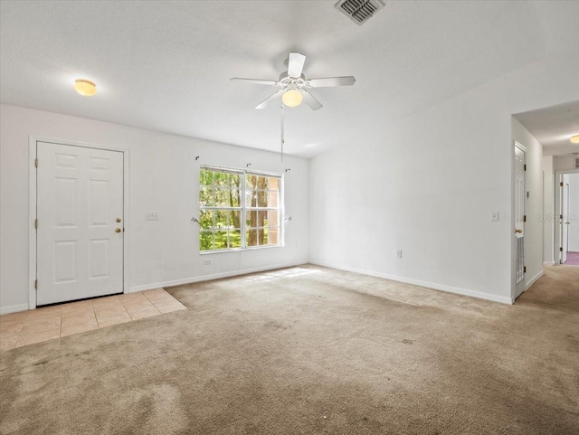 unfurnished living room featuring a textured ceiling, ceiling fan, and light colored carpet