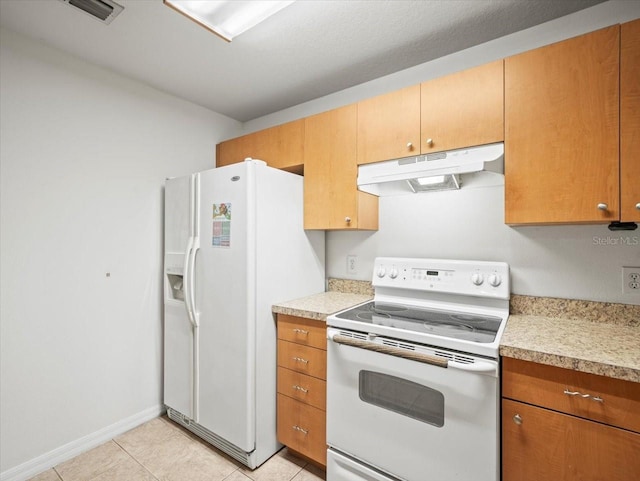 kitchen with white appliances and light tile patterned floors