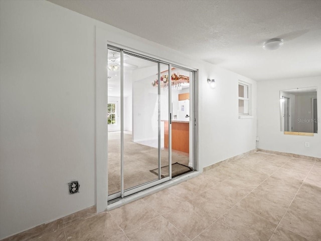 unfurnished room featuring a textured ceiling