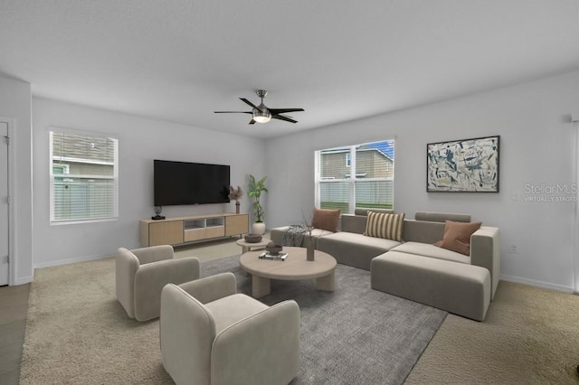 carpeted living room with ceiling fan