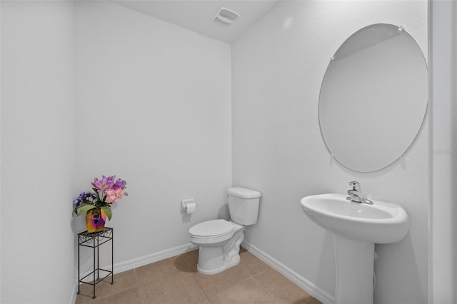 bathroom with tile patterned flooring and toilet