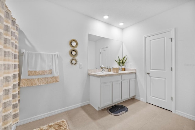 bathroom with tile patterned flooring and vanity