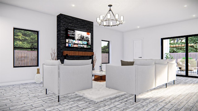 living room with an inviting chandelier, light hardwood / wood-style floors, and plenty of natural light