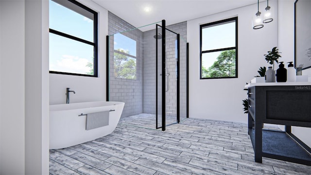 bathroom featuring separate shower and tub, hardwood / wood-style floors, and a wealth of natural light