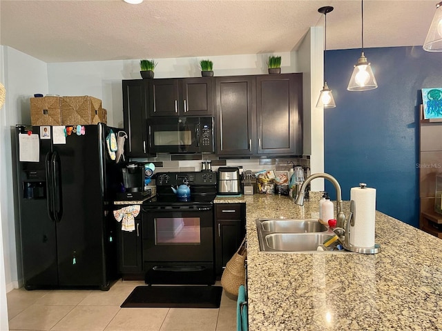 kitchen with pendant lighting, a textured ceiling, sink, and black appliances