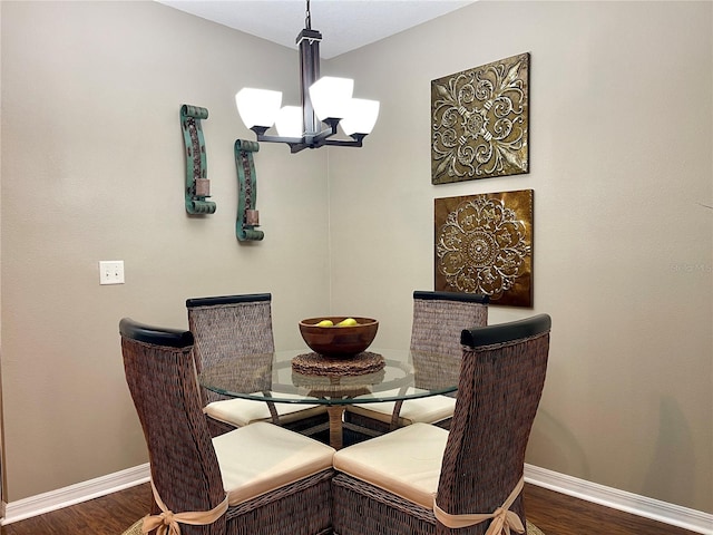 dining area featuring an inviting chandelier and dark hardwood / wood-style flooring