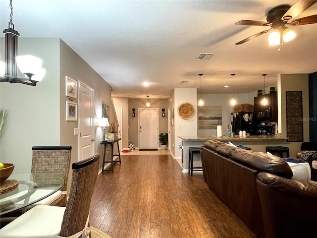 living room featuring ceiling fan, dark wood-type flooring, and sink