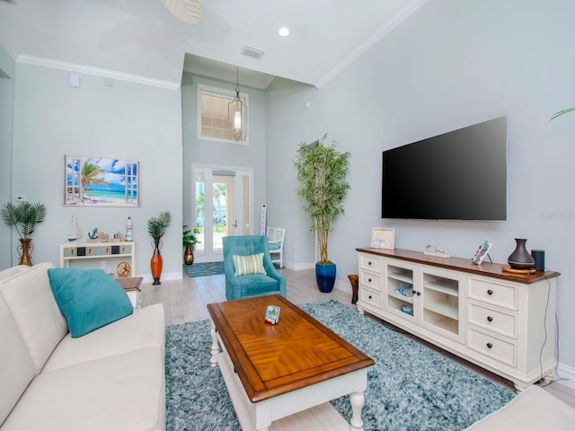 living room with french doors, light hardwood / wood-style flooring, and crown molding