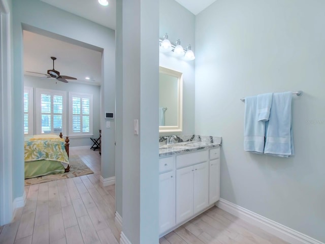 bathroom featuring wood-type flooring, vanity, and ceiling fan